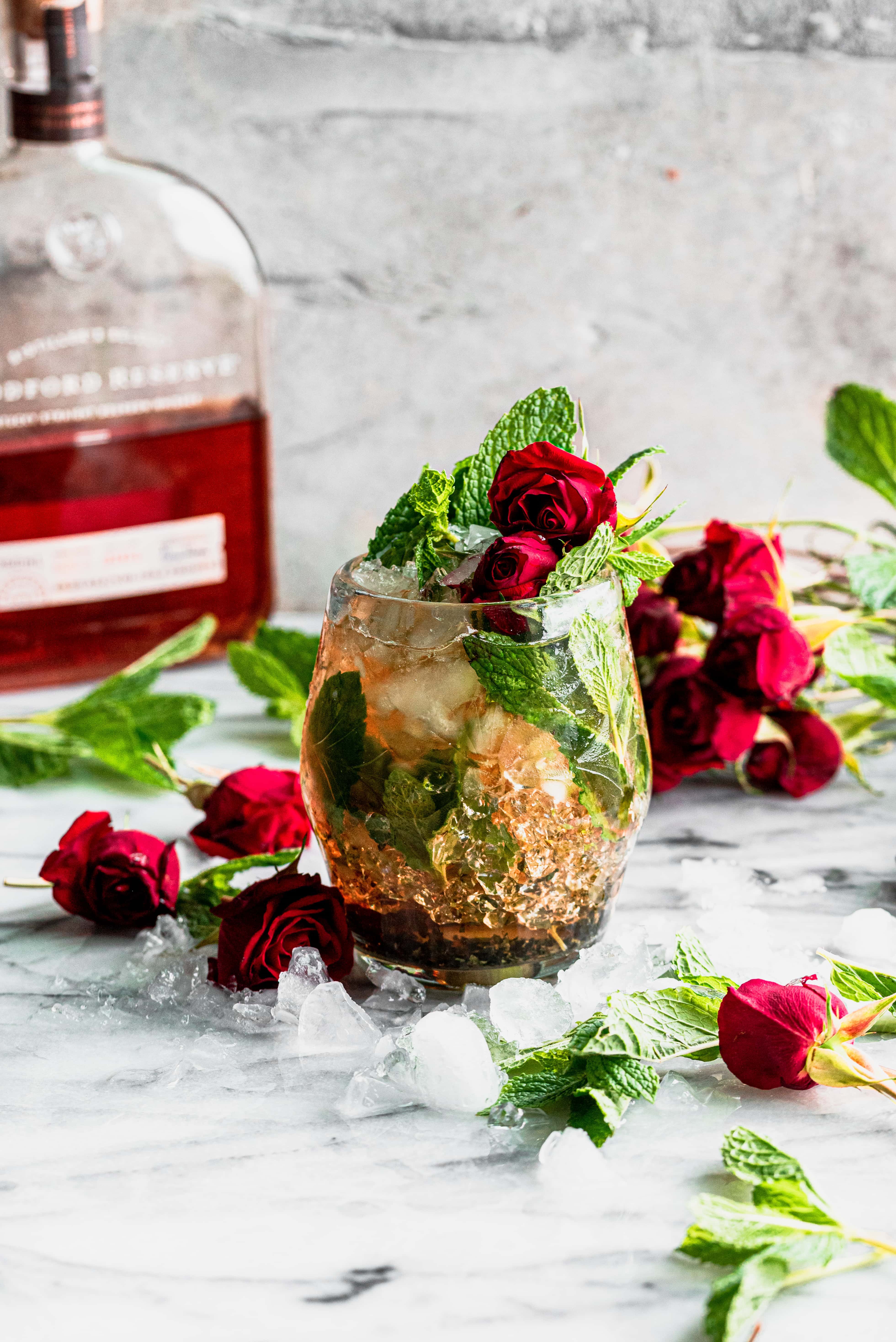 mint julep in a glass with mint and roses