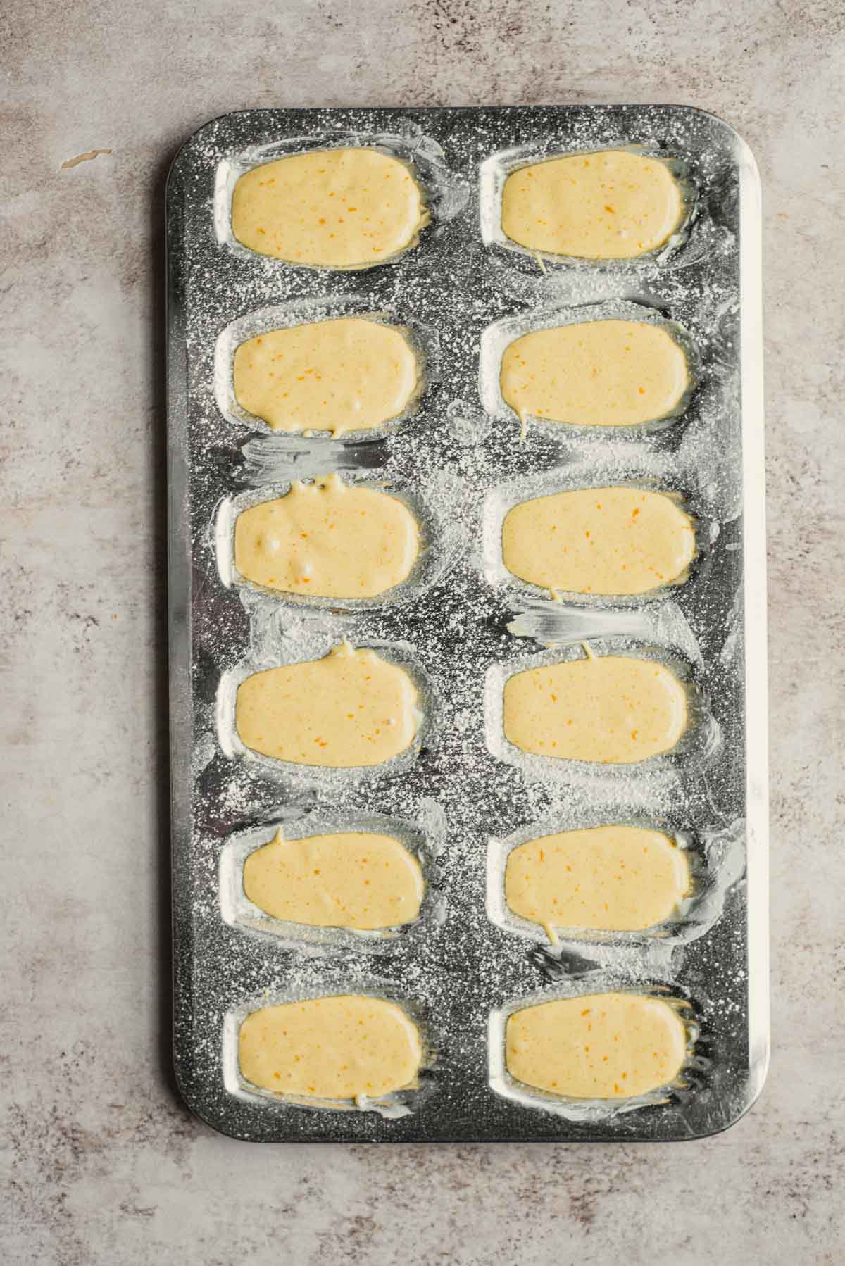 The batter for French madeleines in Madeleine mold.