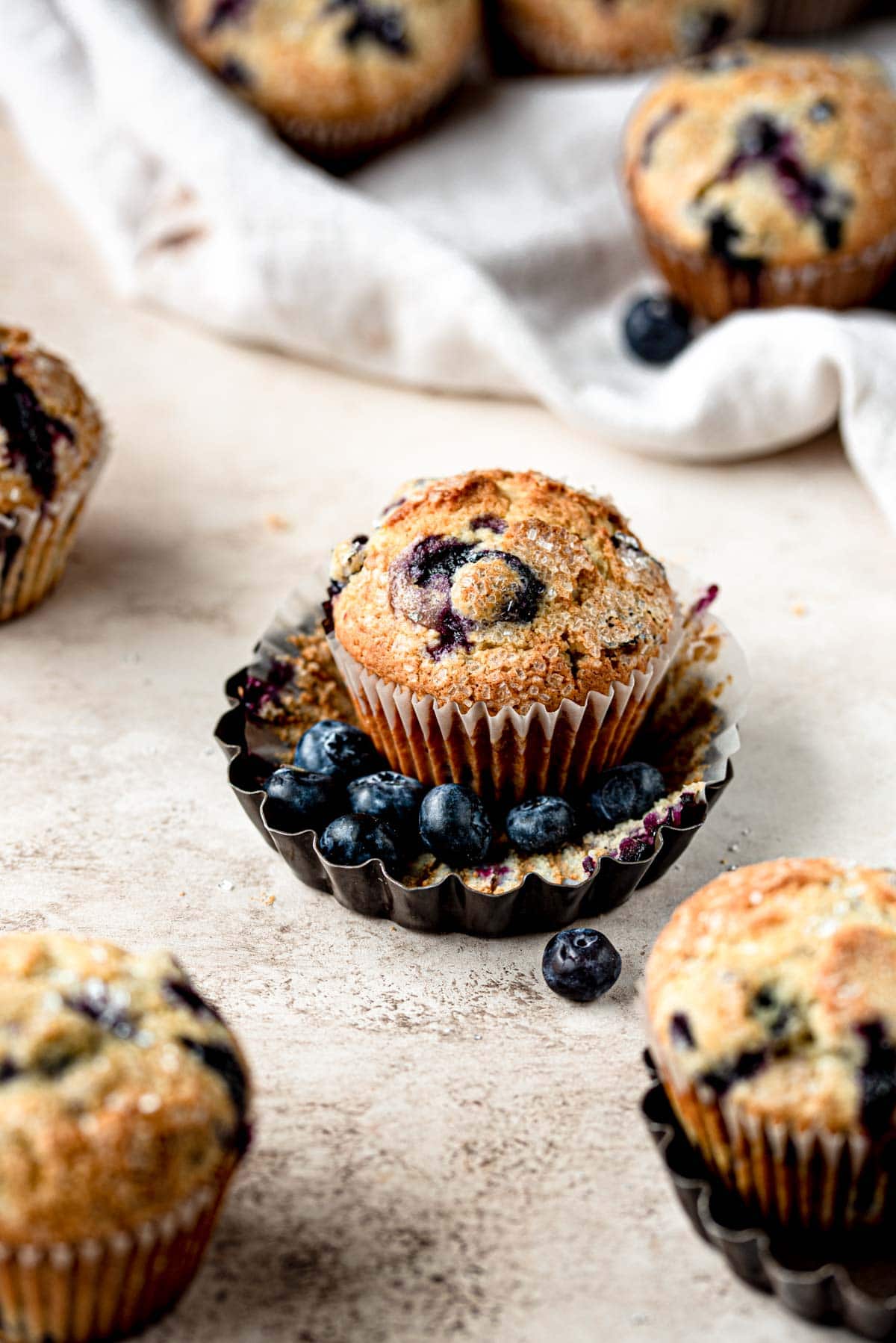 Blueberry muffins in a mini tart pan with blueberries.
