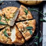 Focaccia sliced and covered with herbs