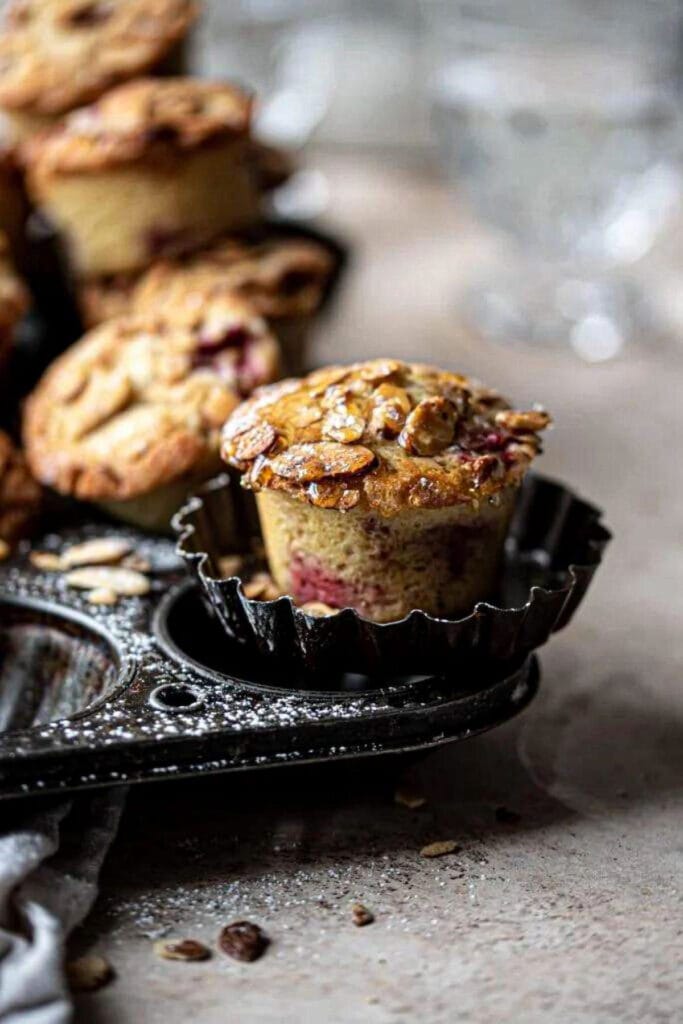 Raspberry almond muffin on a vintage muffin tray.