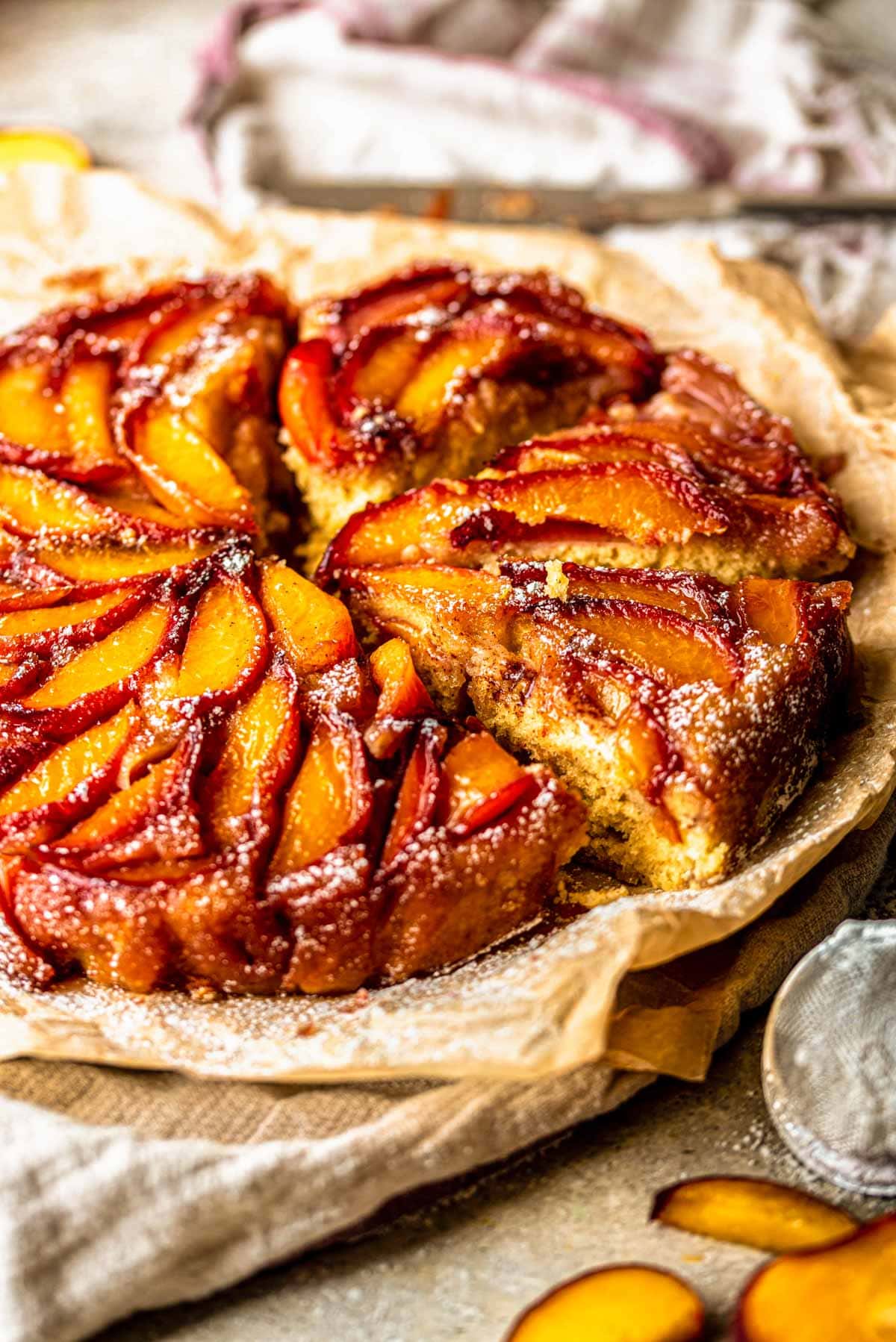 peach upside down cake cut into three slices on brown sheet paper.
