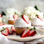 Strawberry Shortcake Cupcake on a plate with fresh strawberries