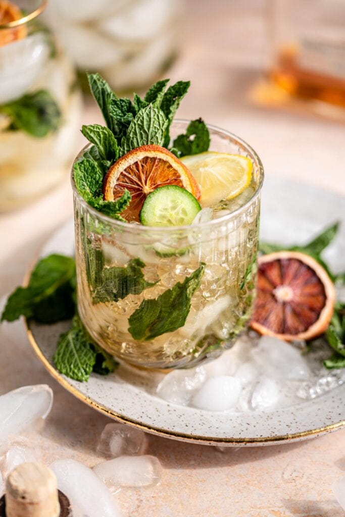 Mint julep garnished with lemon, cucumber, and mint.