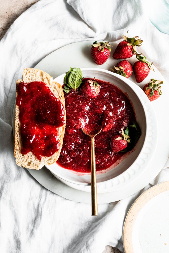 Bourbon Strawberry Jam in a bowl with a spoon and toast on the side