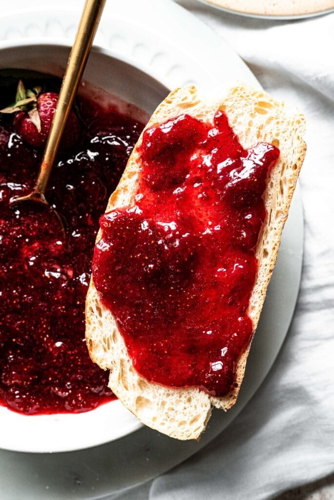 Strawberry jam on toast and on a table 