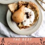 Bourbon Poached pears with folded crepes and whipped cream in a bowl topped with star anise. Fork and spoon are off to the side on a marble platter.