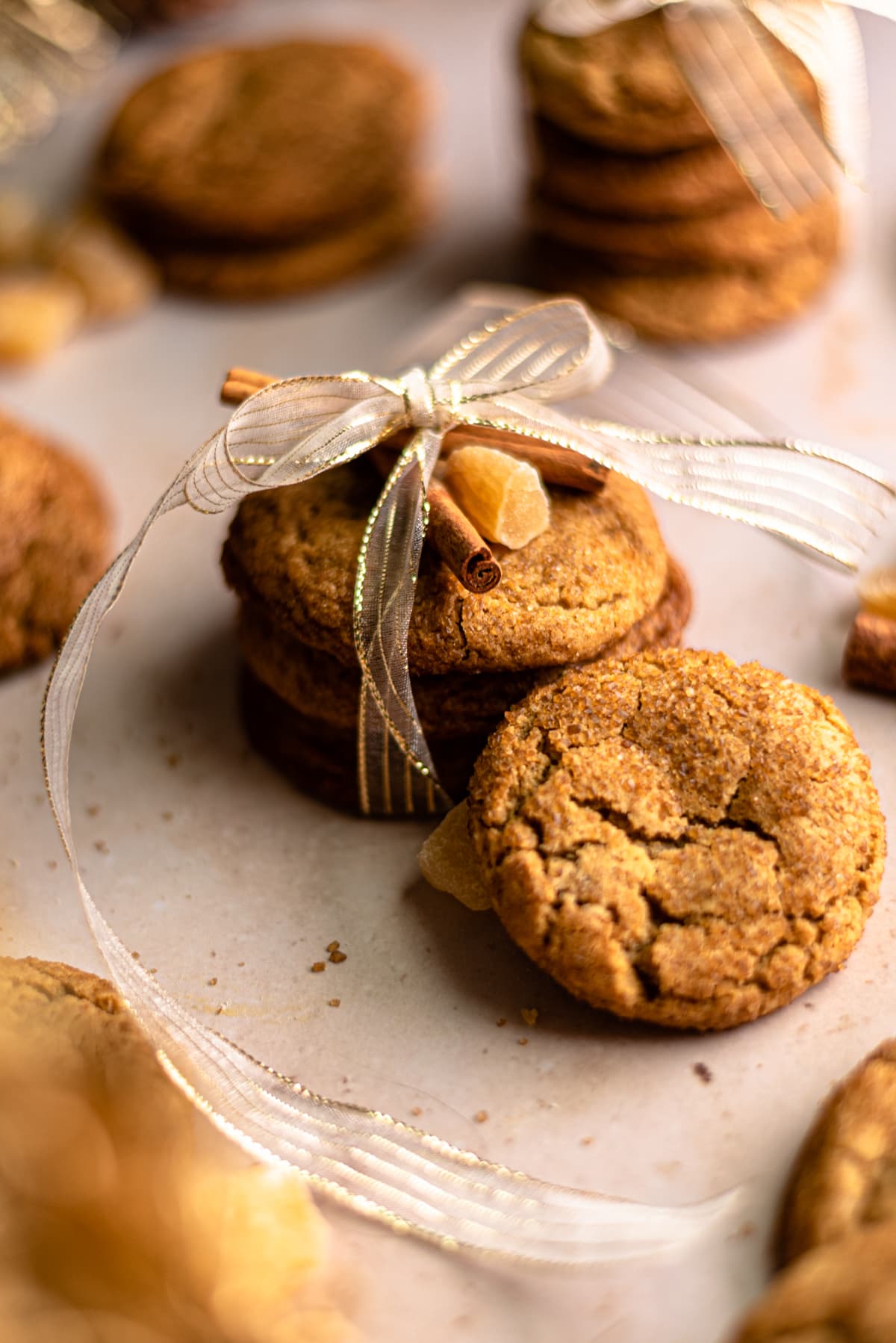 Sorghum cookies wrapped up in ribbon with a cookie leaning against the pile. 