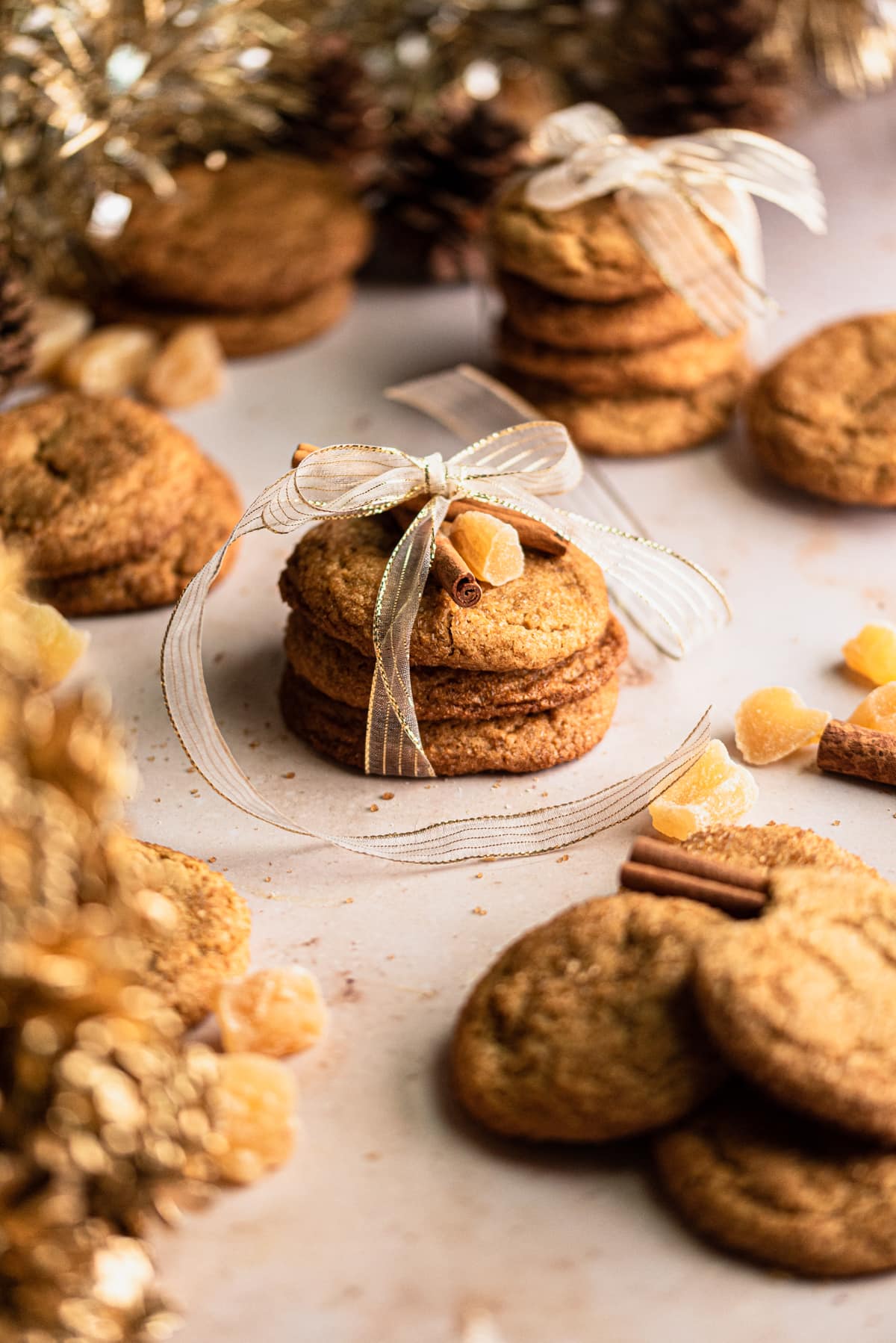 Sorghum cookie wrapped up in gold ribbon on a brown table.