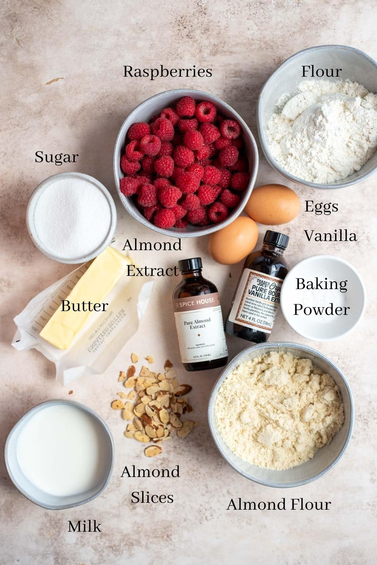 ingredients for raspberry almond muffins on a table.