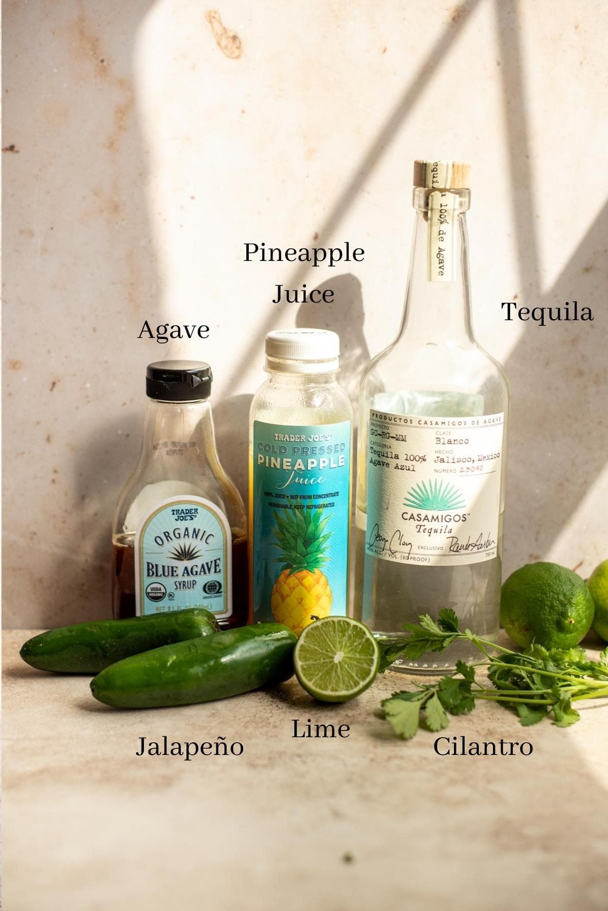 Ingredients for the margaritas lined up against a wall.