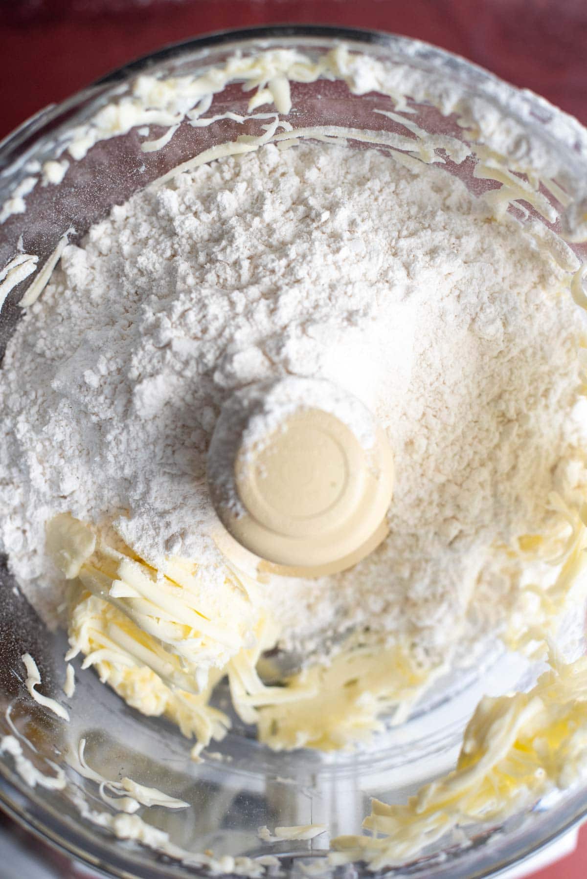 Add the flour to the grated butter.