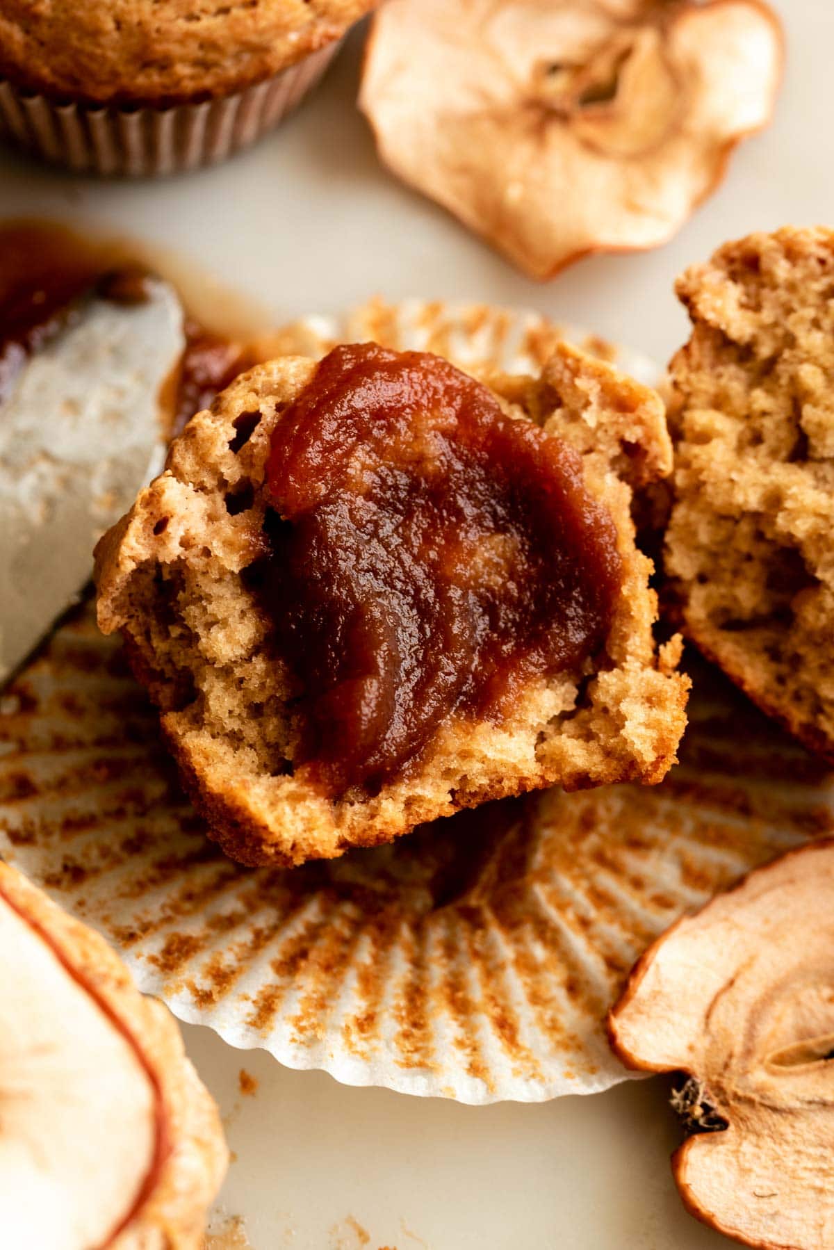 Apple butter muffin split in half and smeared with apple butter.