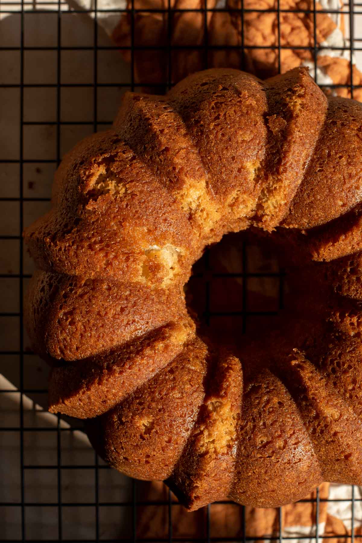The baked bunt cake cooling on a rack.
