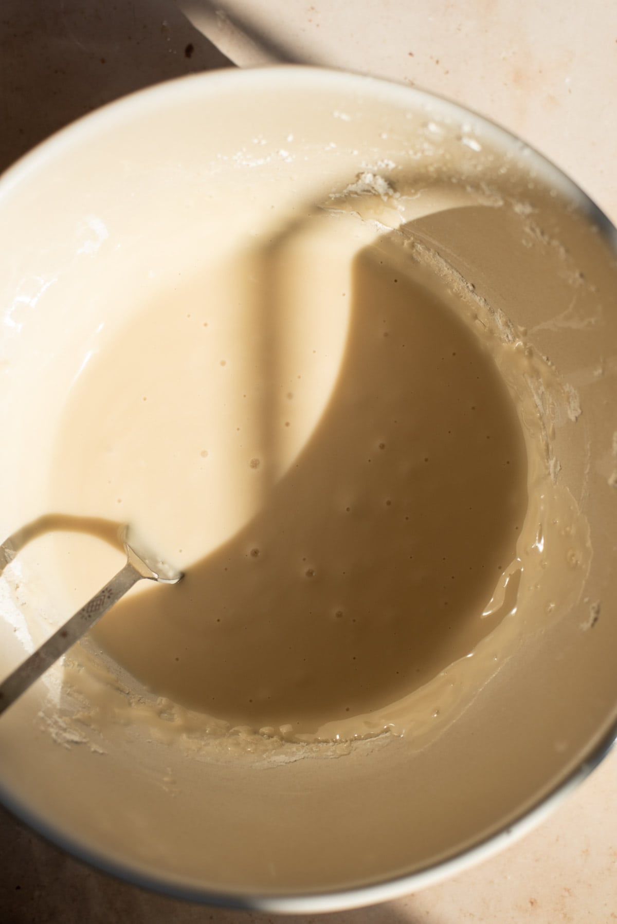 The glaze in a cream mixing bowl.