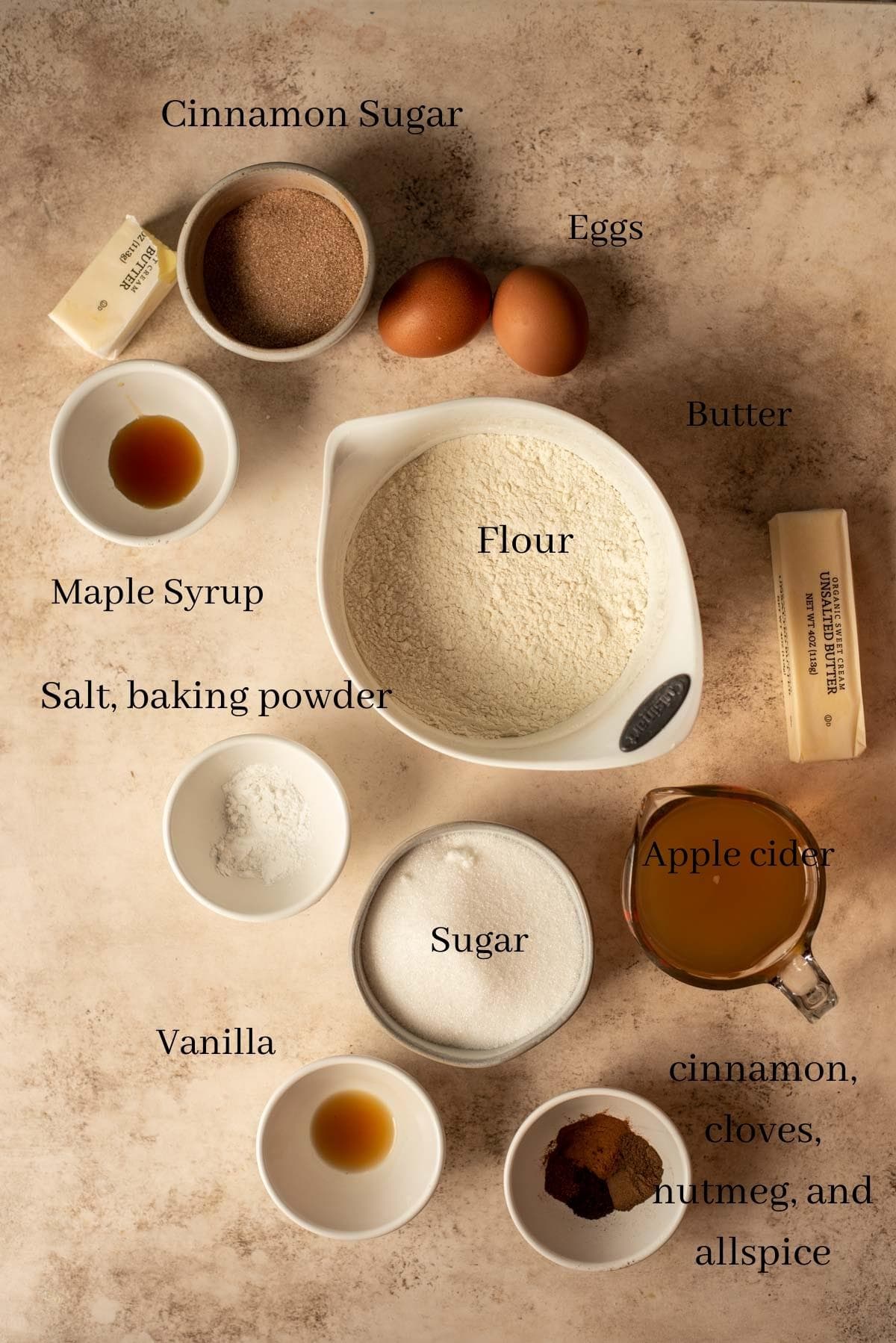 The ingredients for the muffins on a brown stone table.