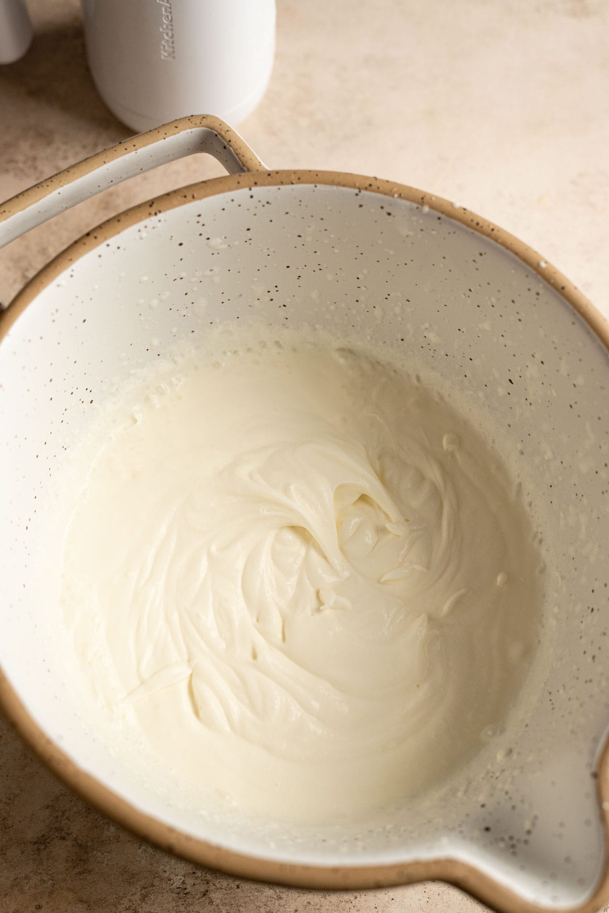 Whipped cream with soft peaks.
