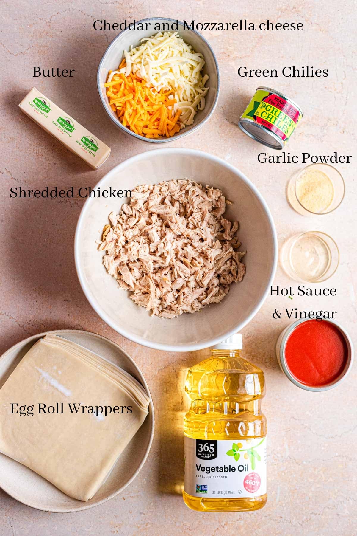 Ingredients for the buffalo chicken egg rolls on a brown table.
