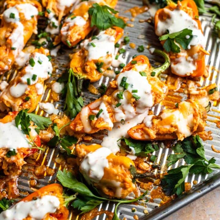 Mini sweet peppers filled with buffalo chicken and drizzled with blue cheese.