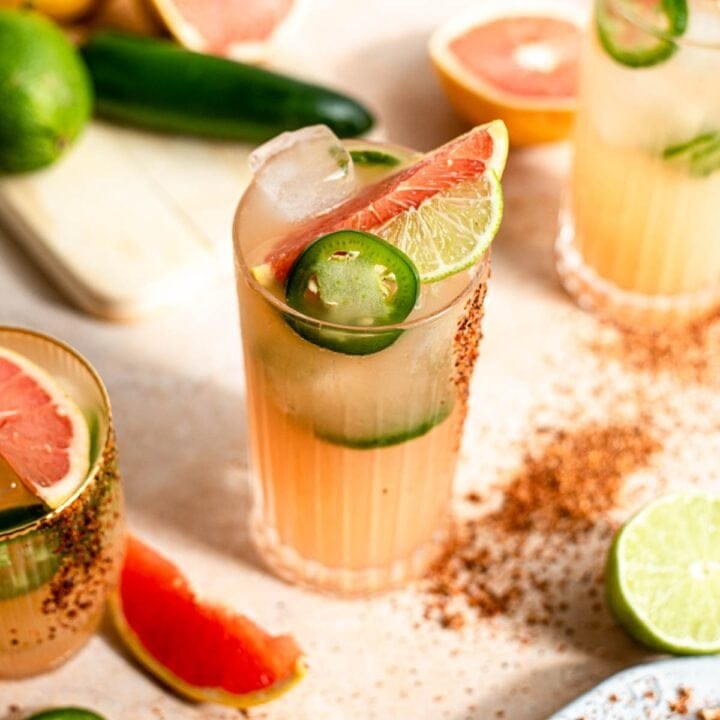 Overhead shot of ranch water in a highball glass and garnished with slices of grapefruit, lime, and jalapeño.