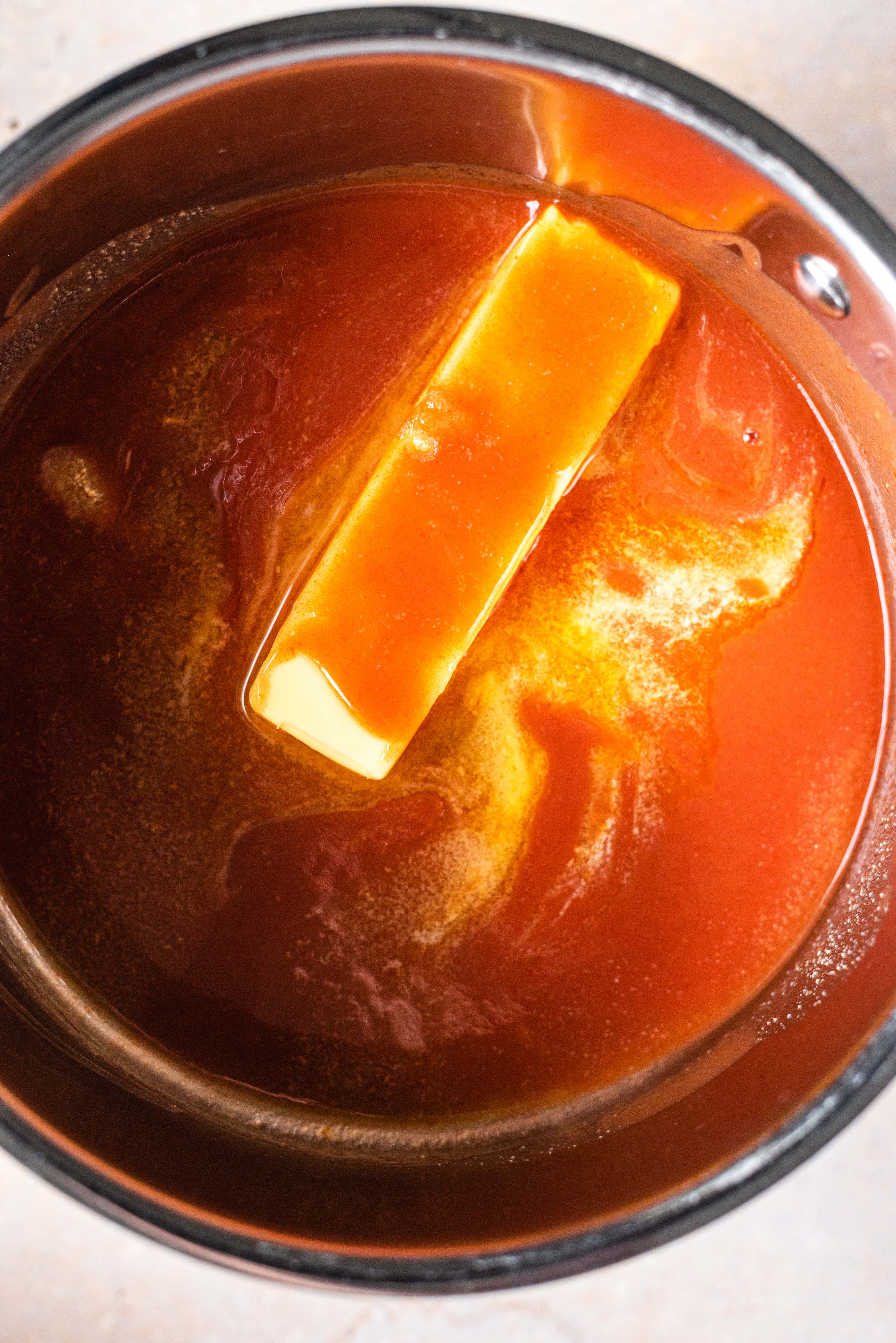 The ingredients for the buffalo sauce in a sauce pan.