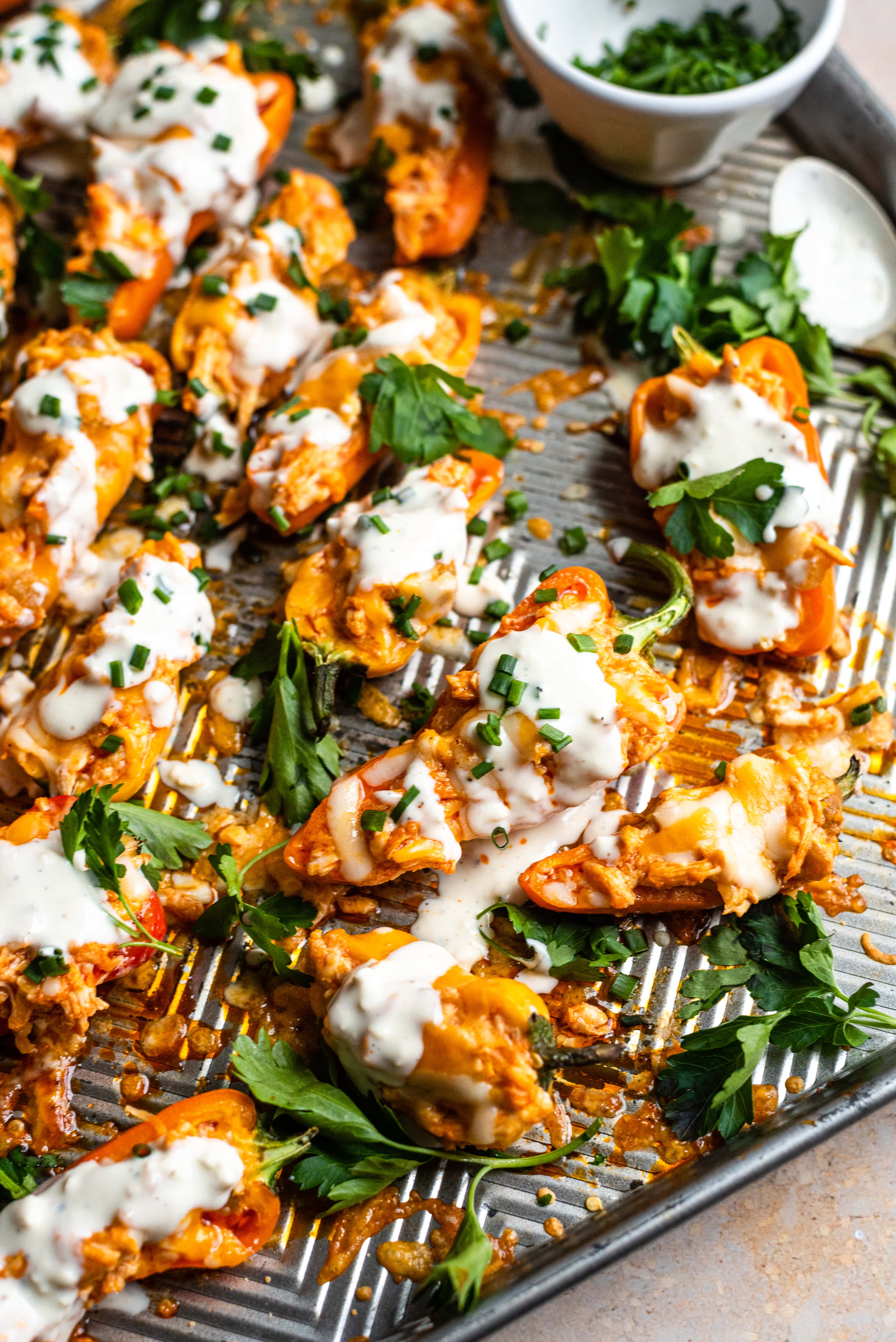 Mini sweet peppers filled with buffalo chicken and drizzled with blue cheese.