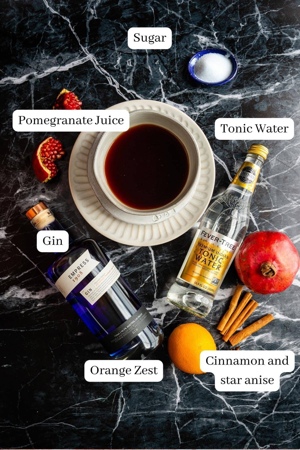 The ingredients for the cocktail on a black marble table.