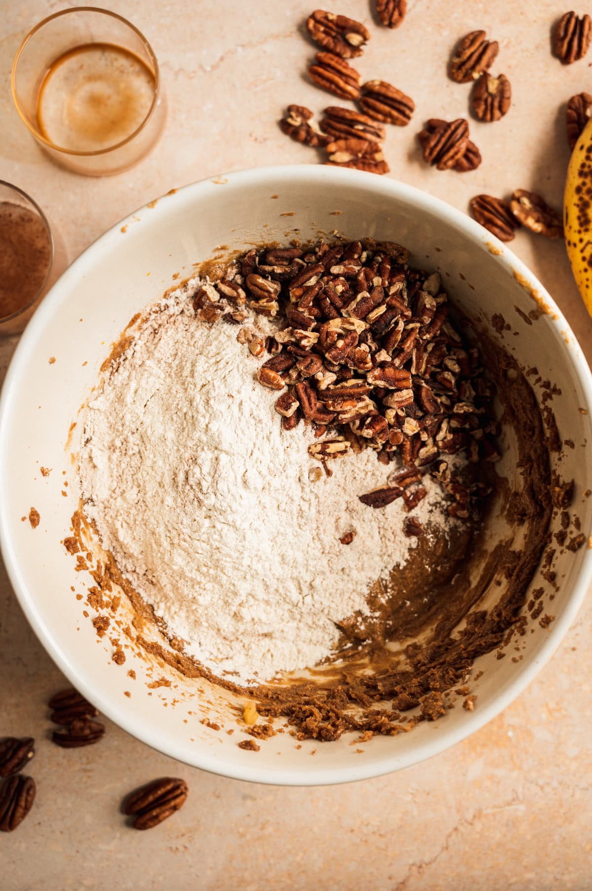 The flour and pecans added to the bowl.