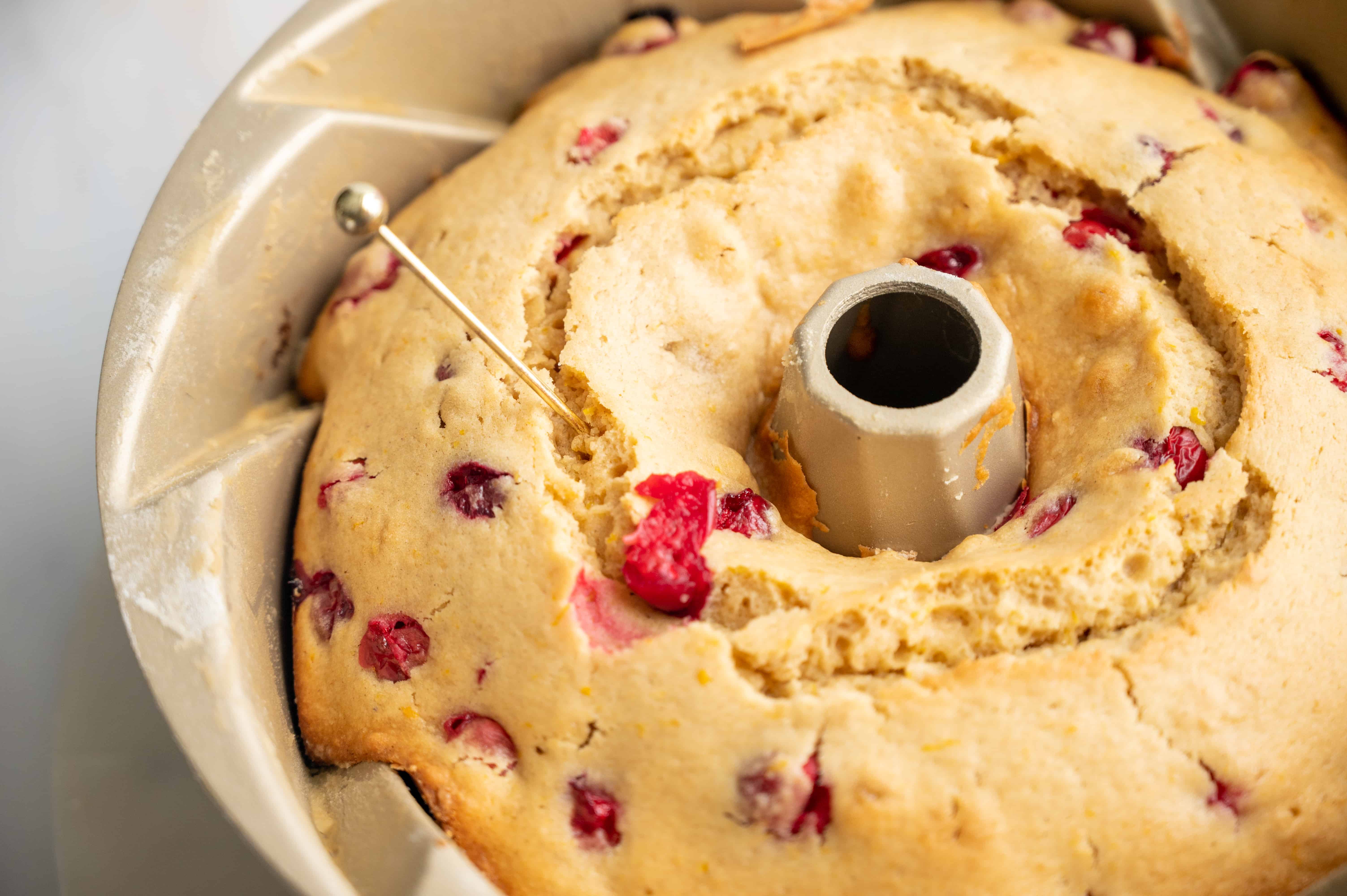 A baked bundt cake with a pin sticking out.
