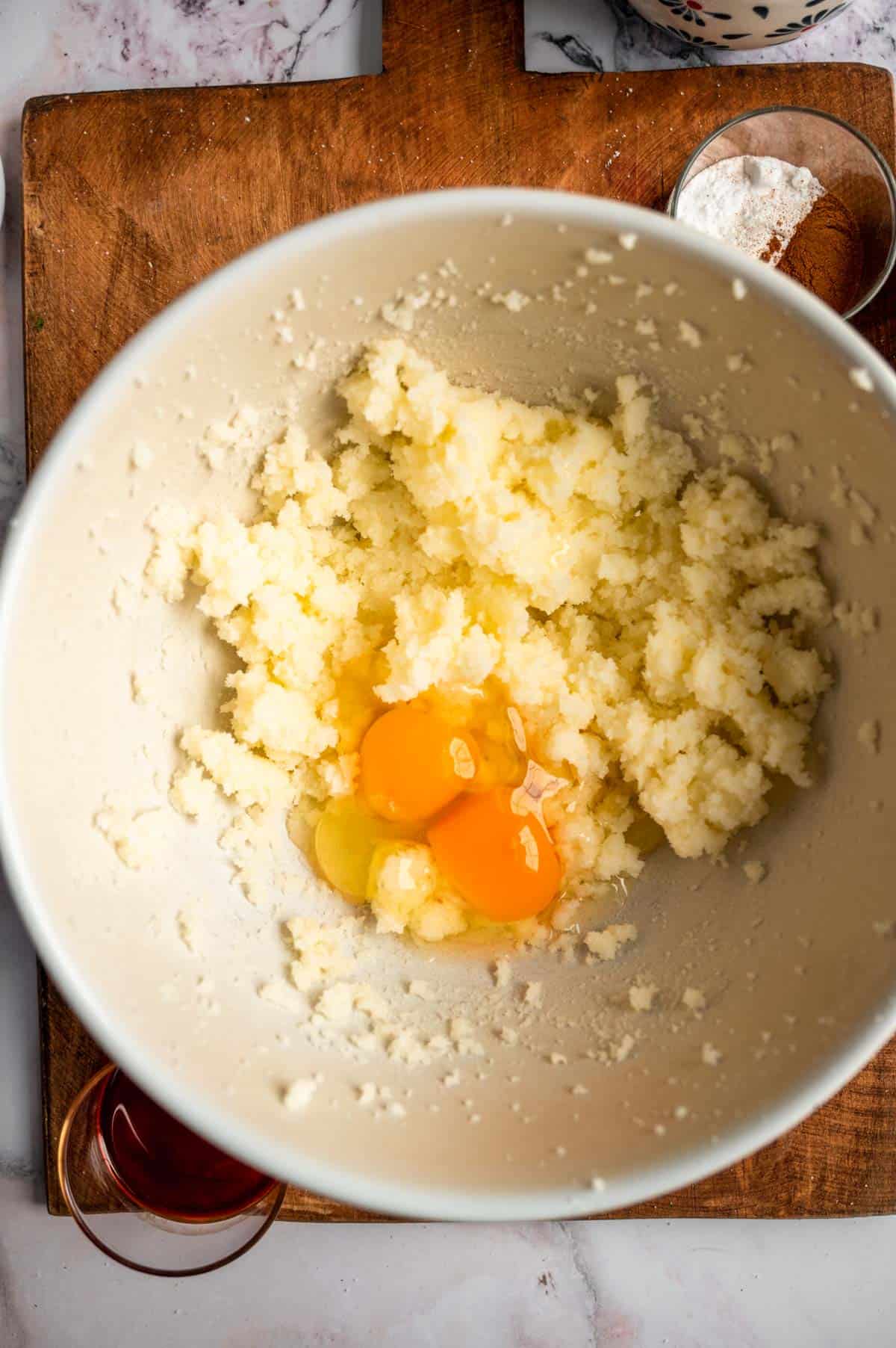 The mixed butter and sugar with 2 eggs sitting in the bowl.