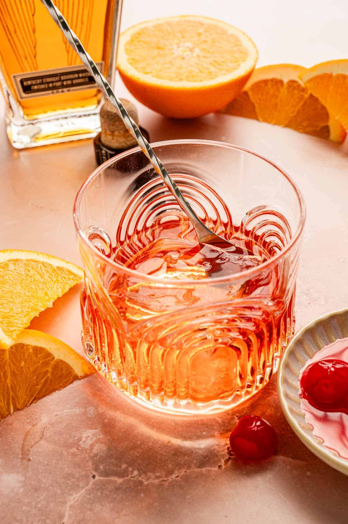 A cocktail stirrer is stirring the drink.
