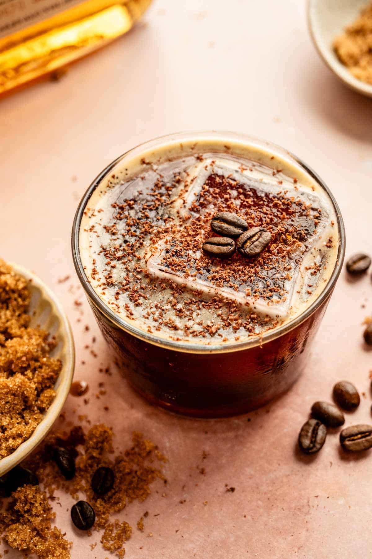 The cocktail has been garnished with chocolate shavings and espresso beans.