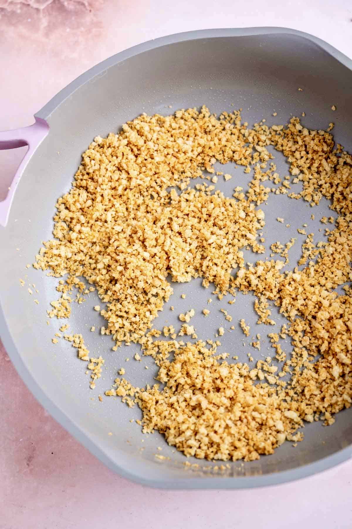 Toasted bread crumbs in a large frying pan.
