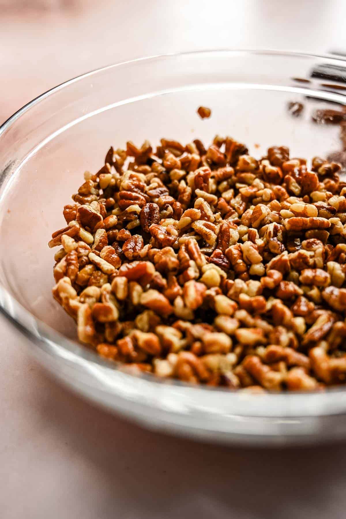 The pecans and bourbon sitting in a small bowl.