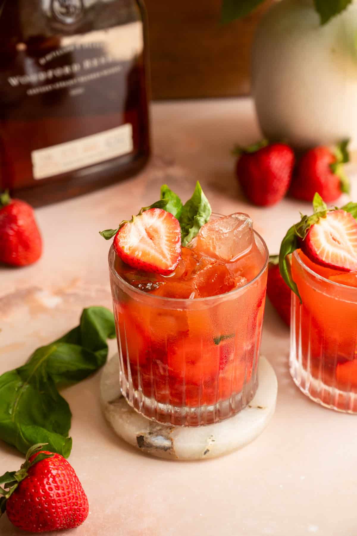 the finished cocktail garnished with ½ strawberry and basil.