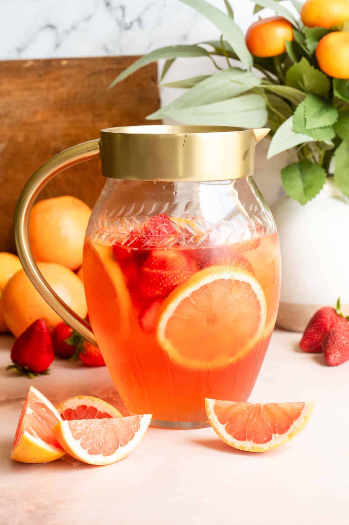 Grapefruit and strawberry slices have been added to the pitcher.