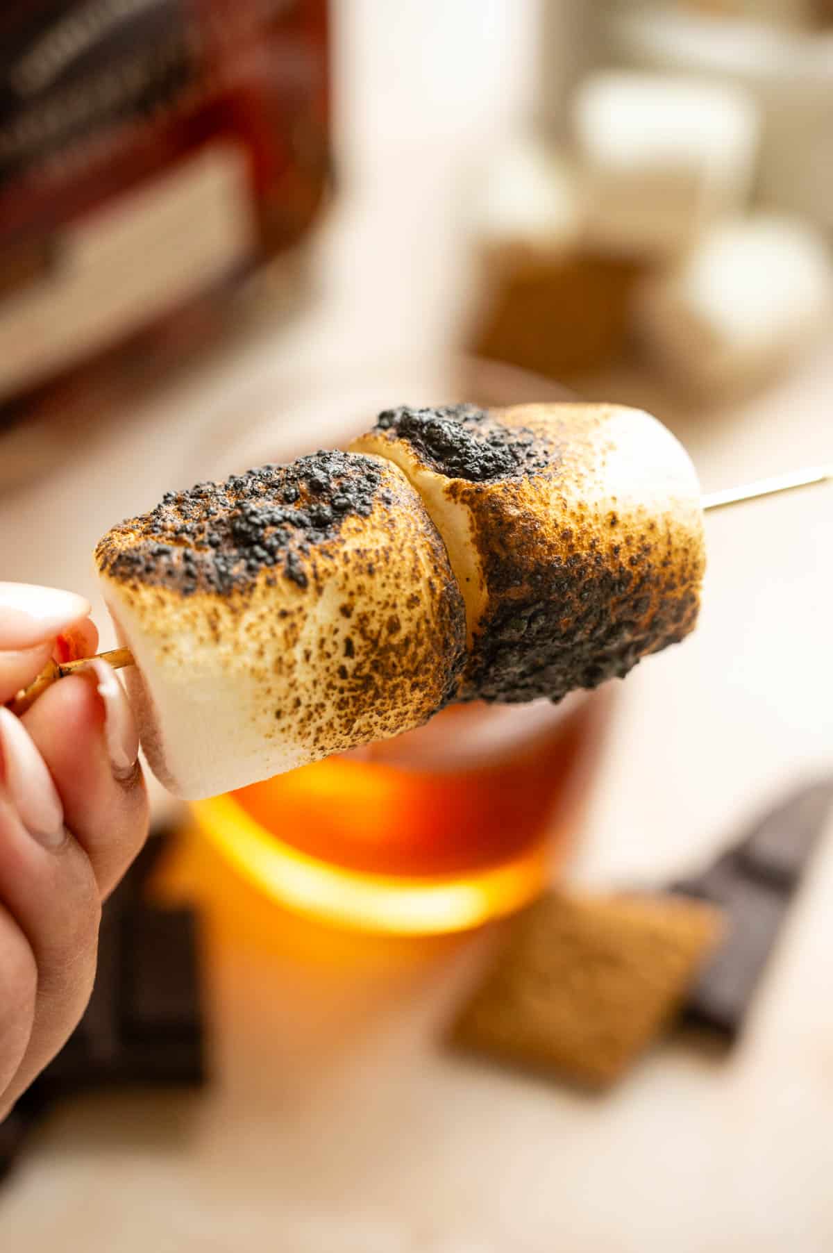 Toasted marshmallows on a cocktail stick.