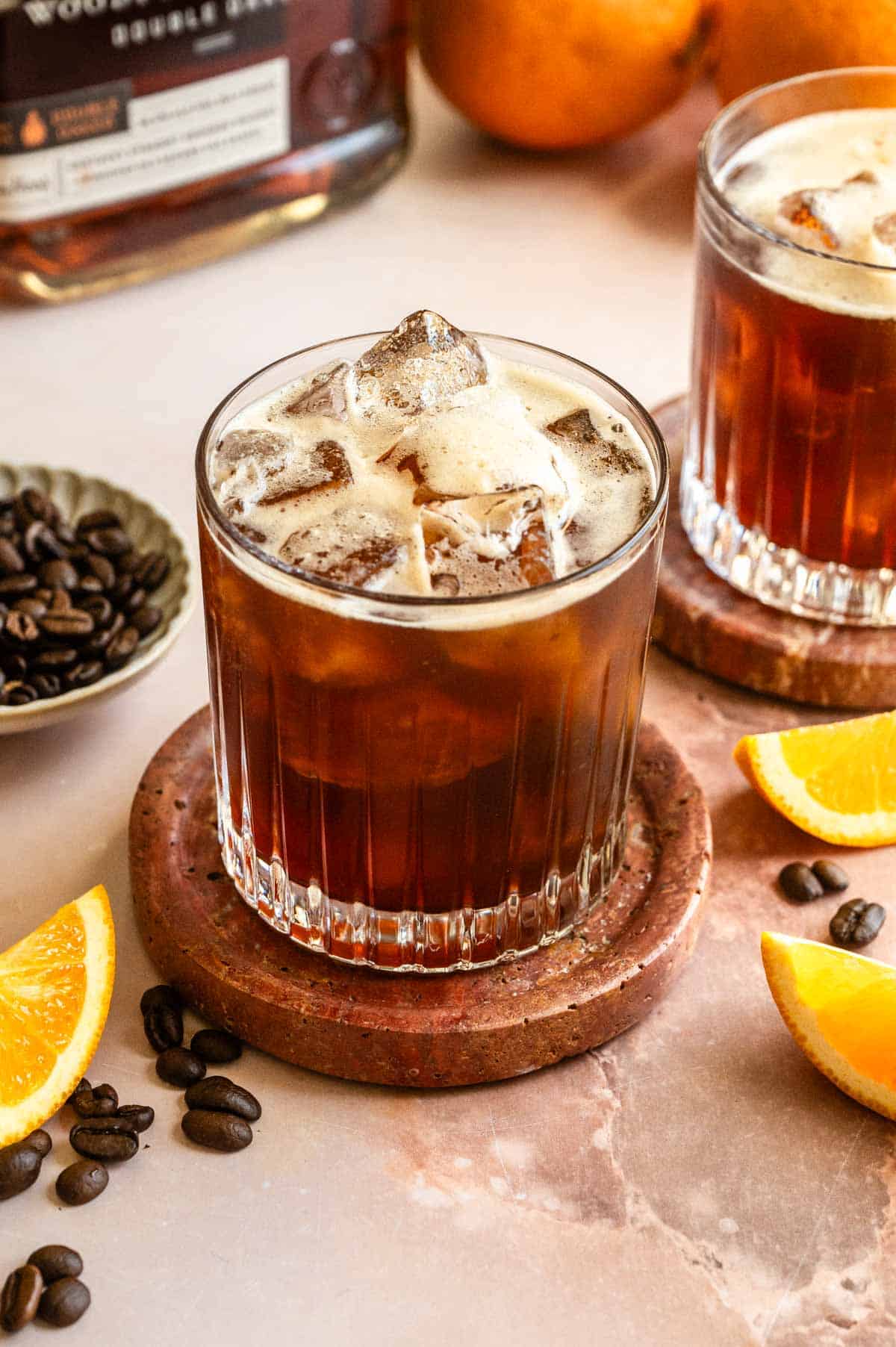 The shaken cocktail in a rocks glass with ice.