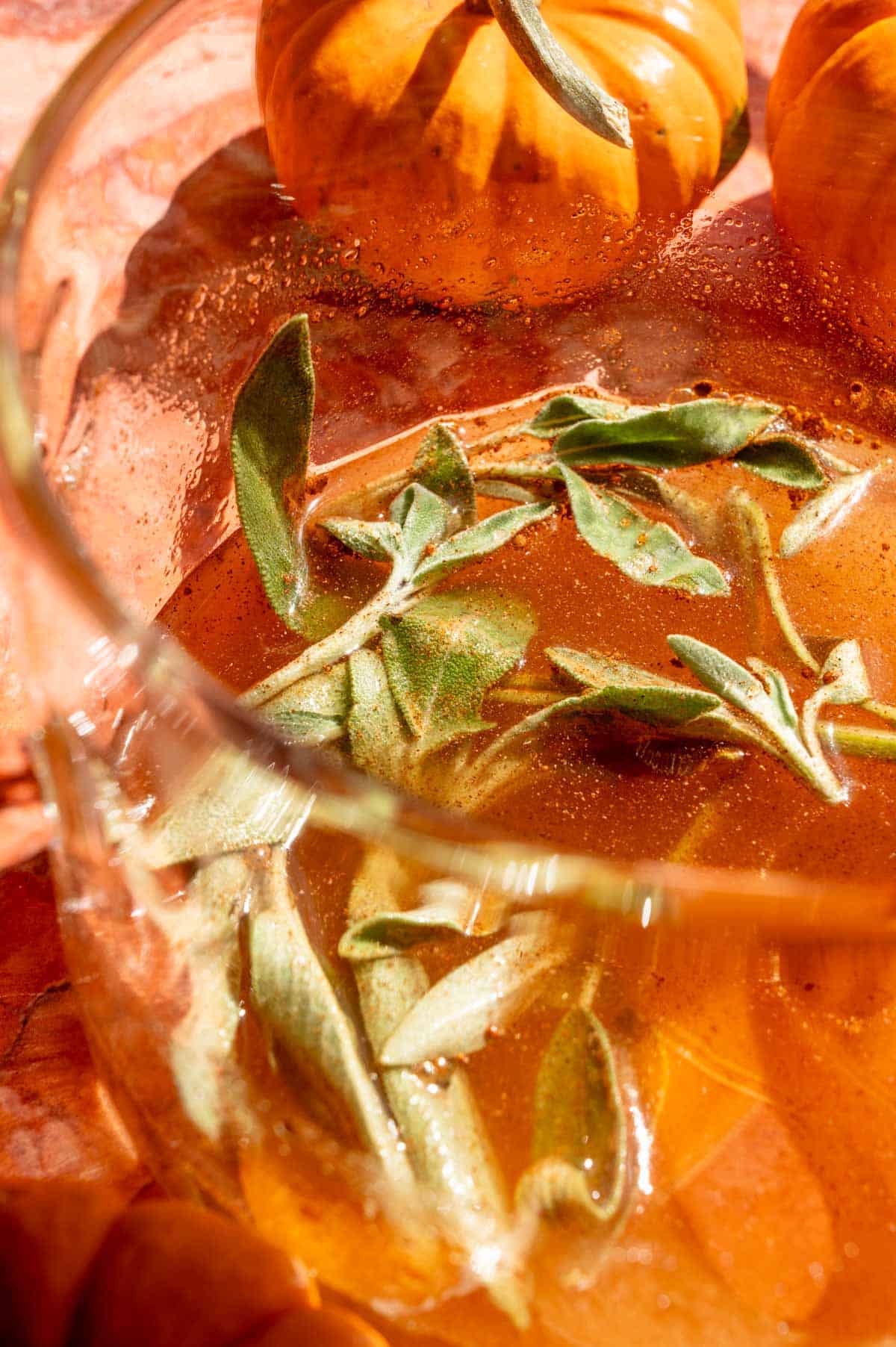 A small glass pot filled with sugar, sage, and pumpkin spice.