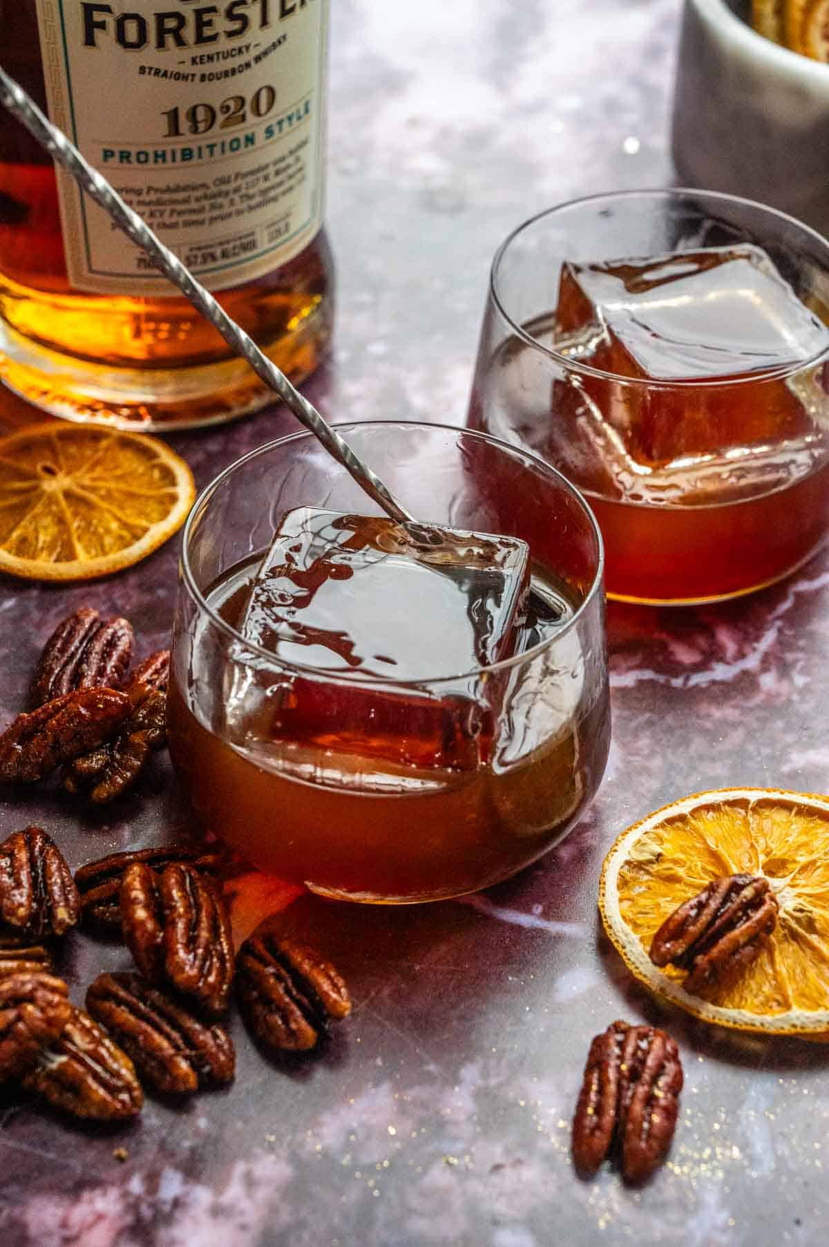 A cocktail stirrer sitting in the glass with the mixed drink.