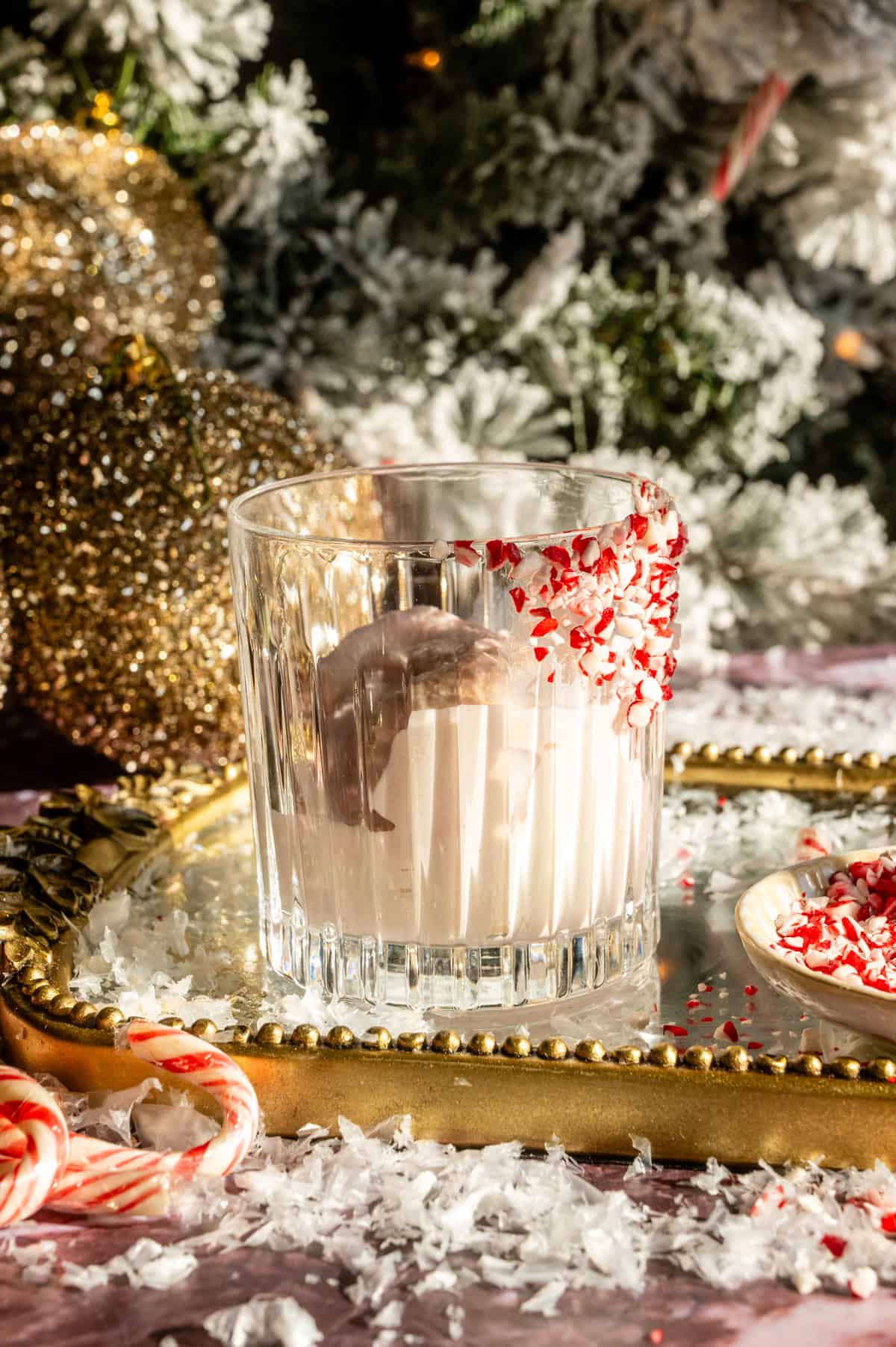 Ice cream in a rocks glass with a peppermint rim.