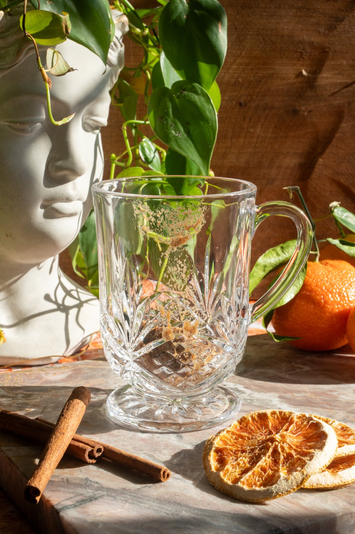 A tablespoon of the butter batter has been added to an etched glass mug.