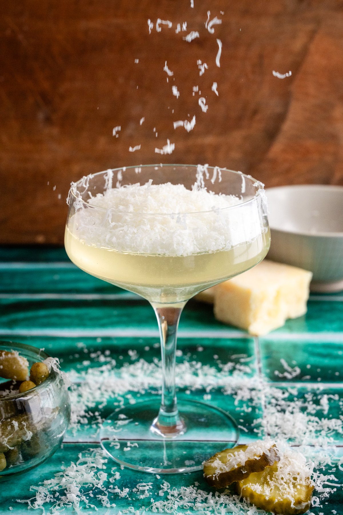 The poured drink is covered with grated parmesan.