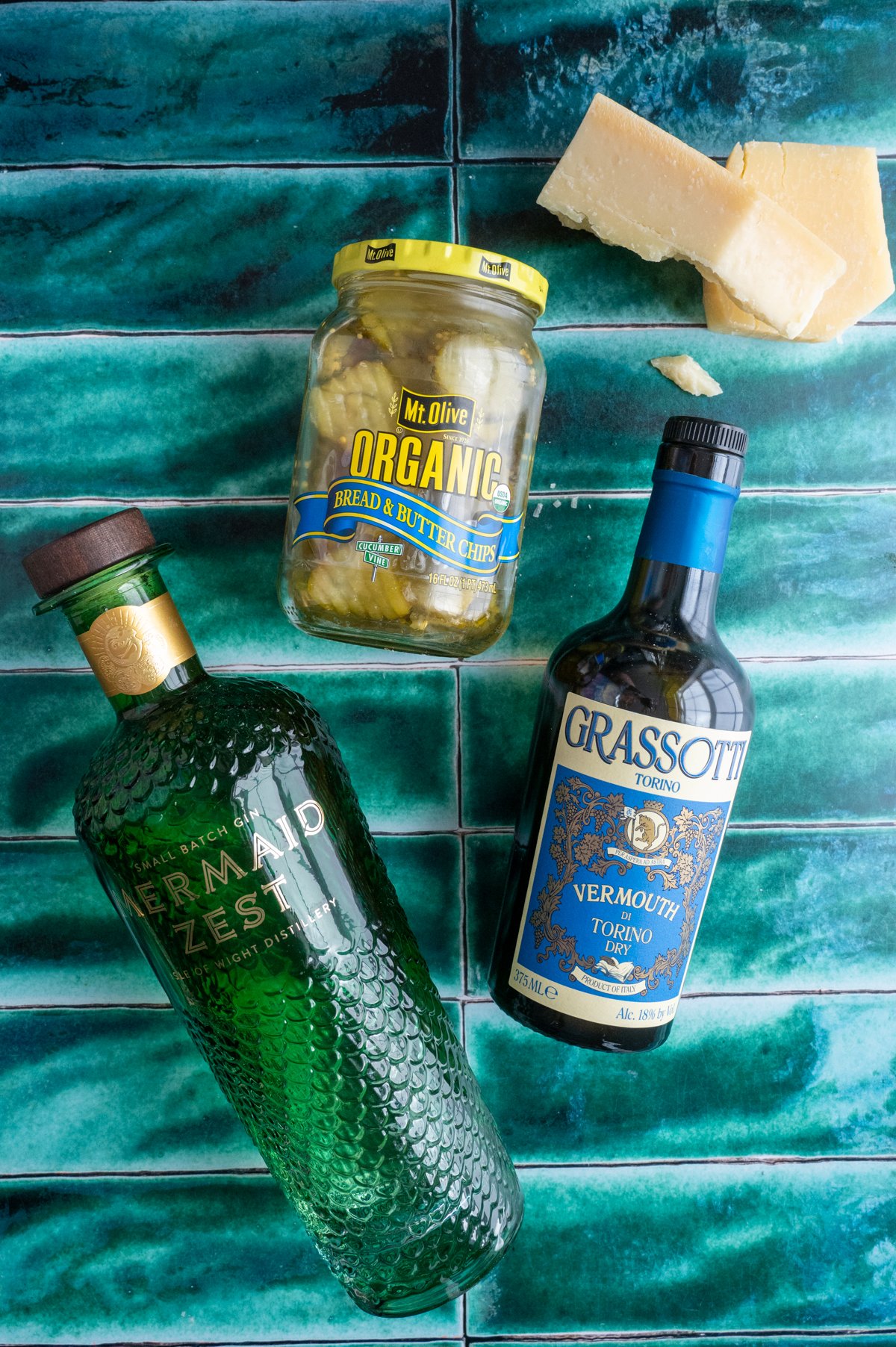 The ingredients for the cocktail on a green tile table.