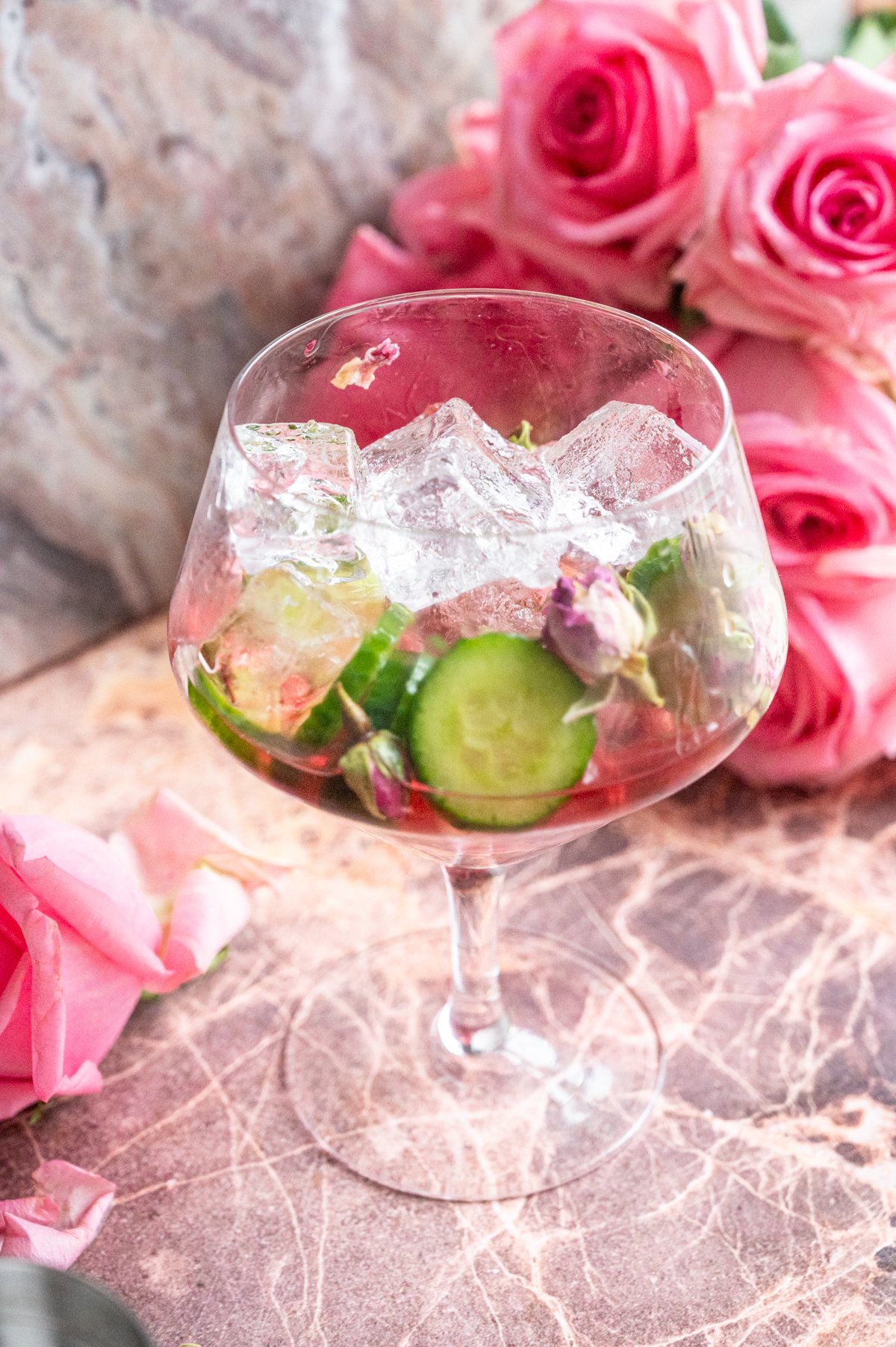 Ice and cucumber have been added to the glass.