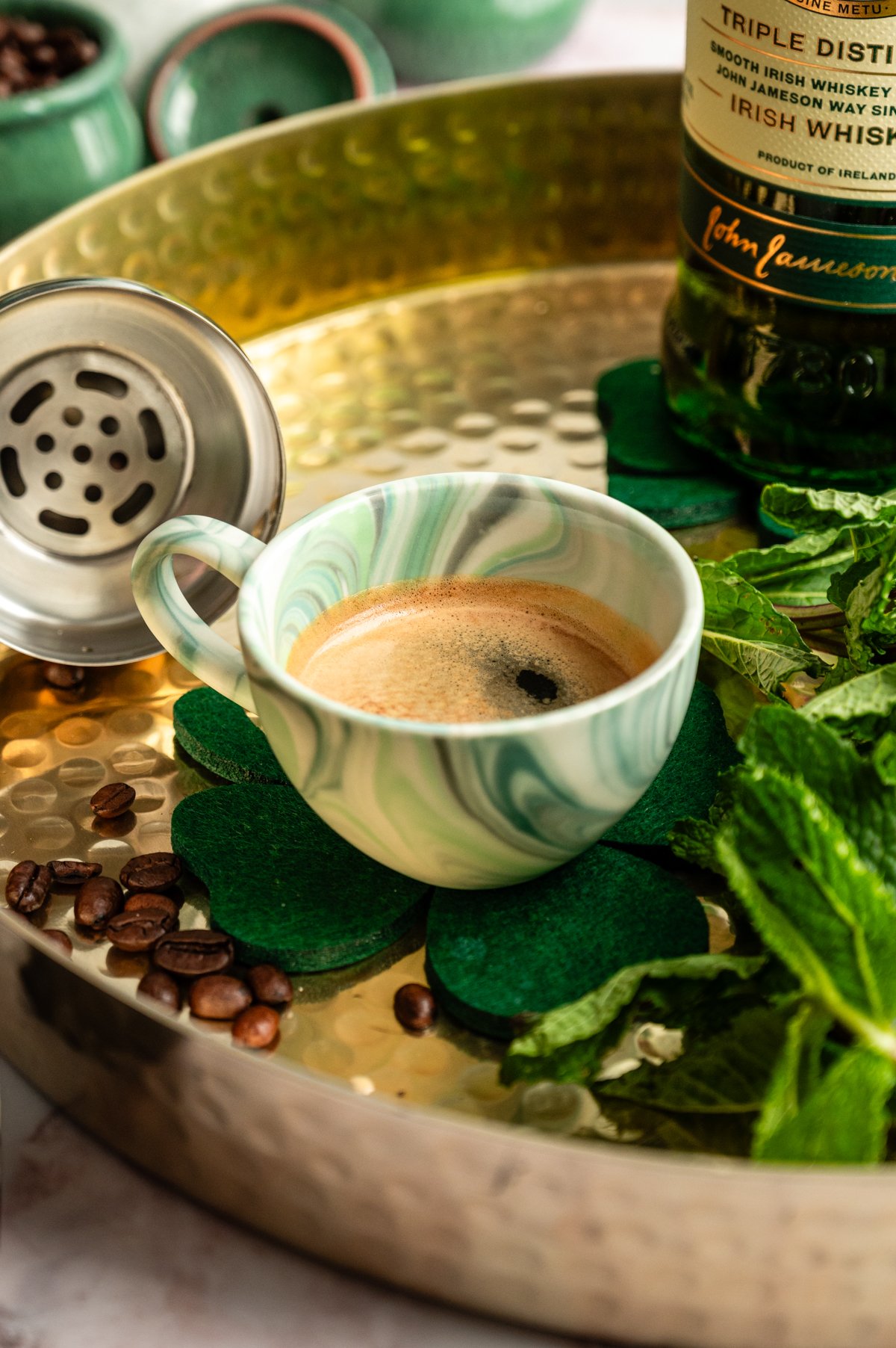 A shot of espresso in a green marble espresso cup.