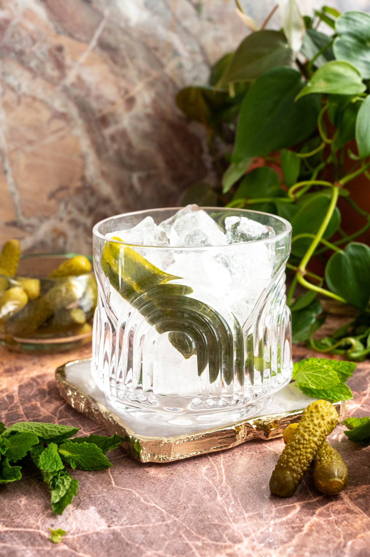 A rocks glass filled with ice and a pickle spear.