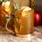 apple crisp mule in a glass mug with a stag handle.