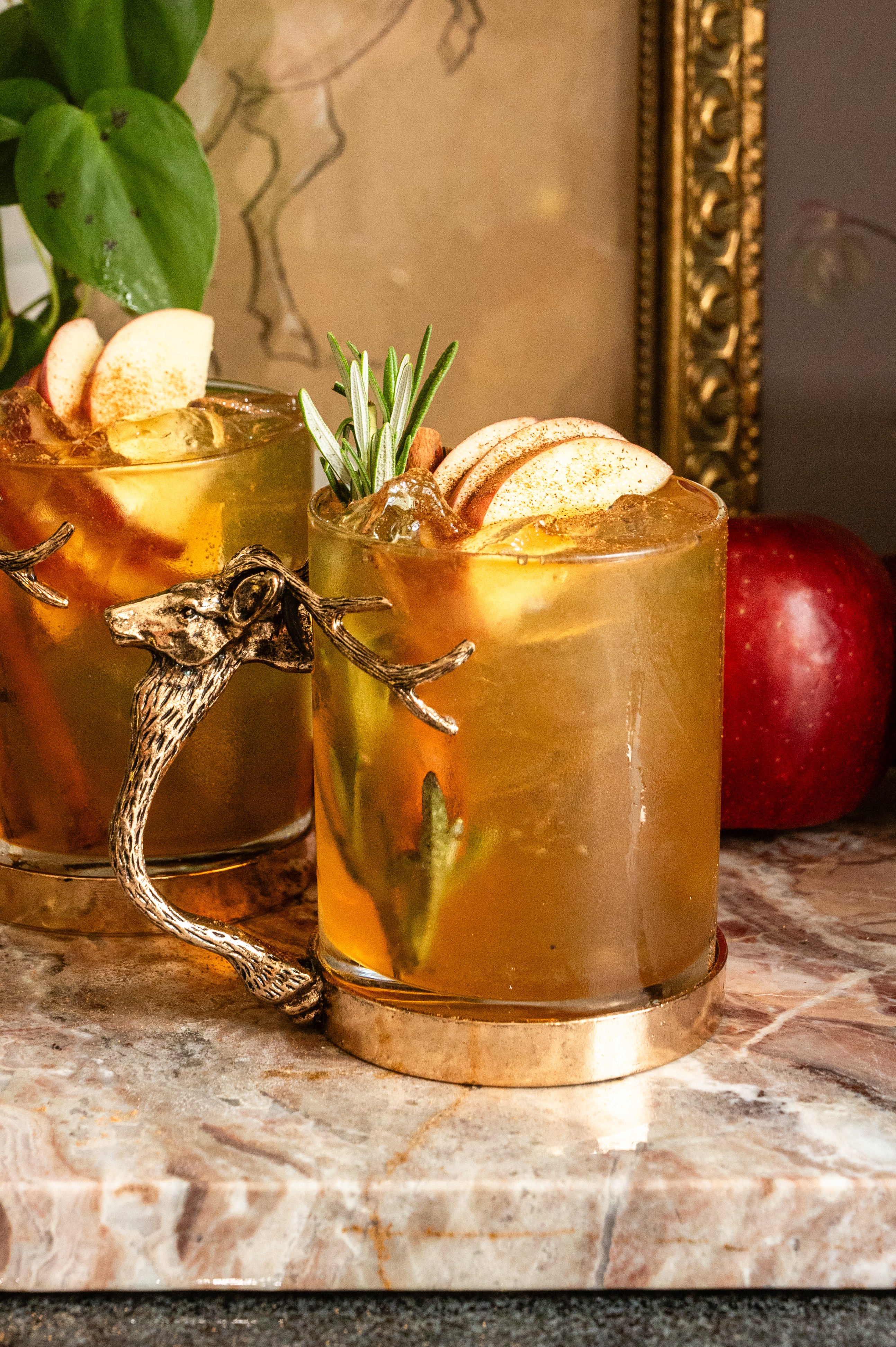 apple crisp mule in a glass mug with a stag handle.