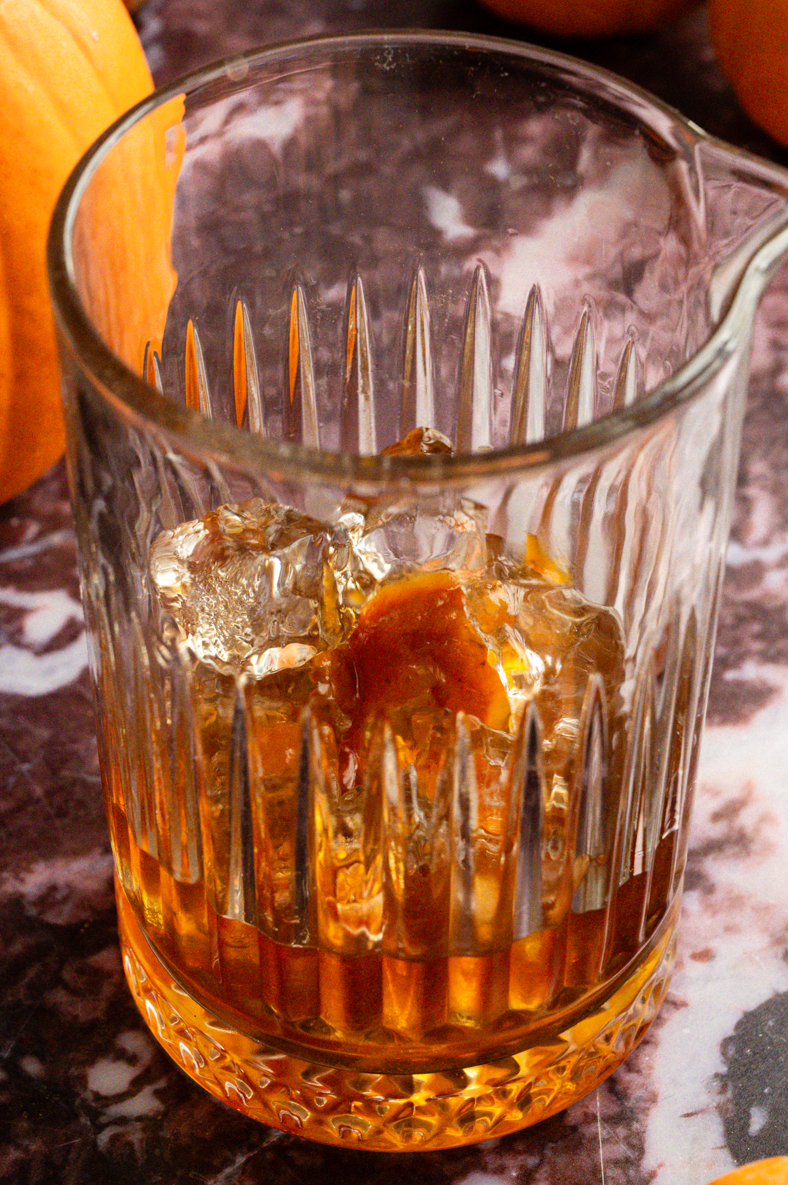 A mixing glass filled with ice and the cocktail ingredients. 